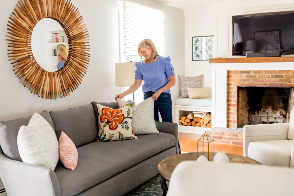 home staging business growth, Lori Fischer staging a home with decorative pillows
